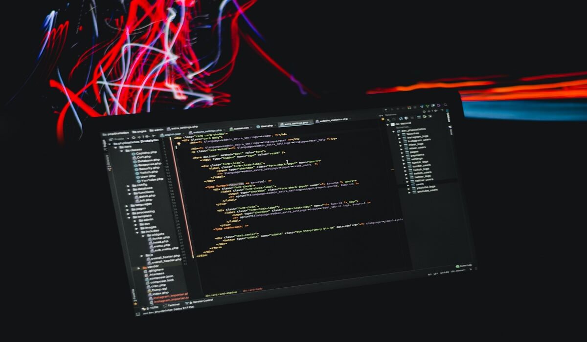 Lines of data streaming to a laptop.