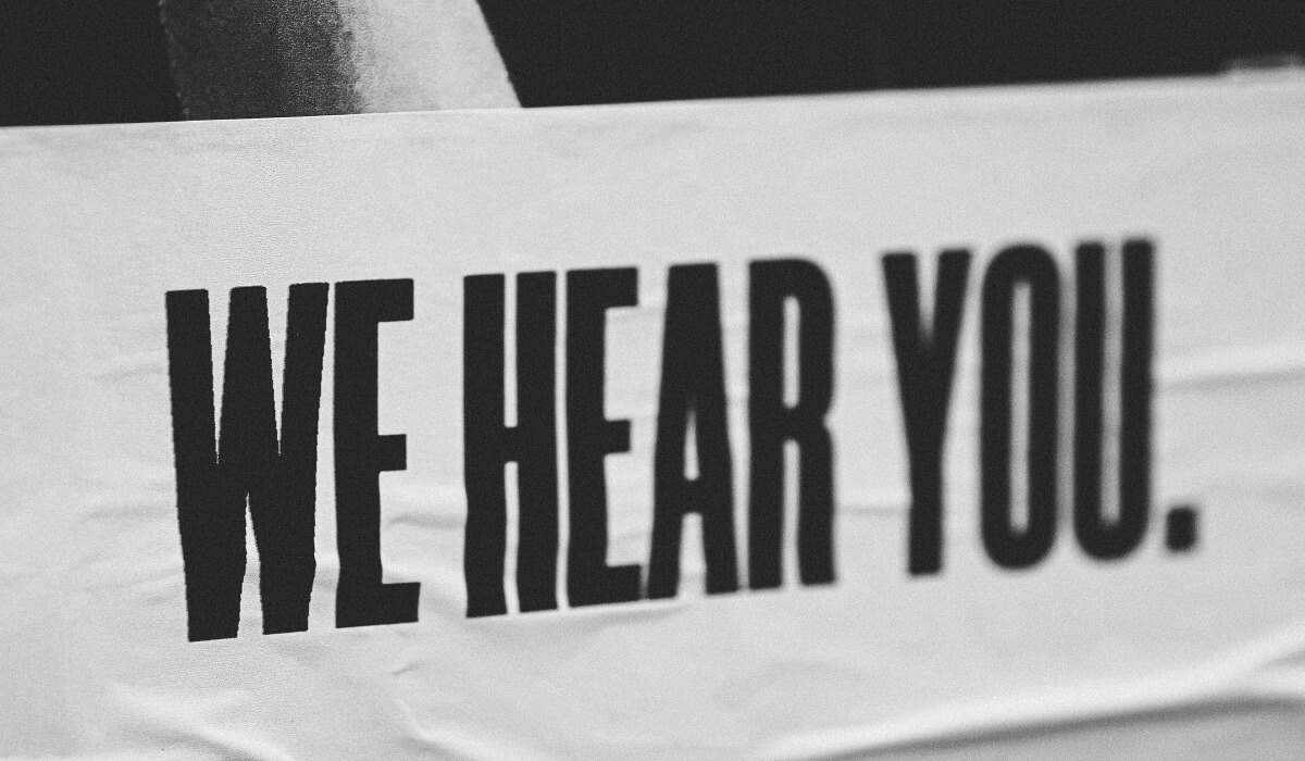 A sign that reads 'WE HEAR YOU'.