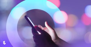 A smartphone in front of purple colors.