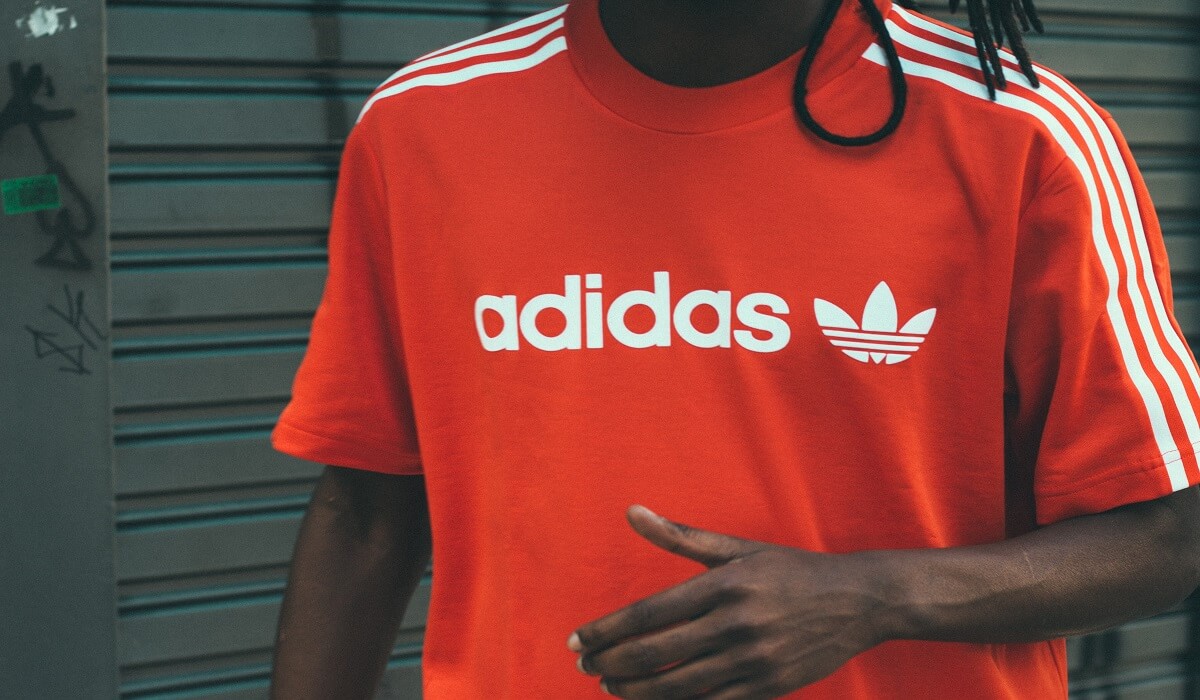 A man wearing an Adidas shirt.